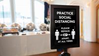 Practice social distancing sign at a dinning